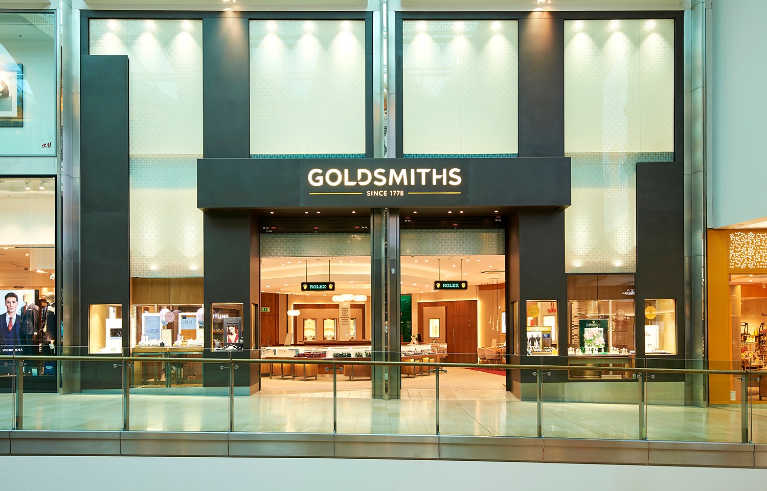 Goldsmiths shopfront with a wide illuminated entrance in a shopping centre