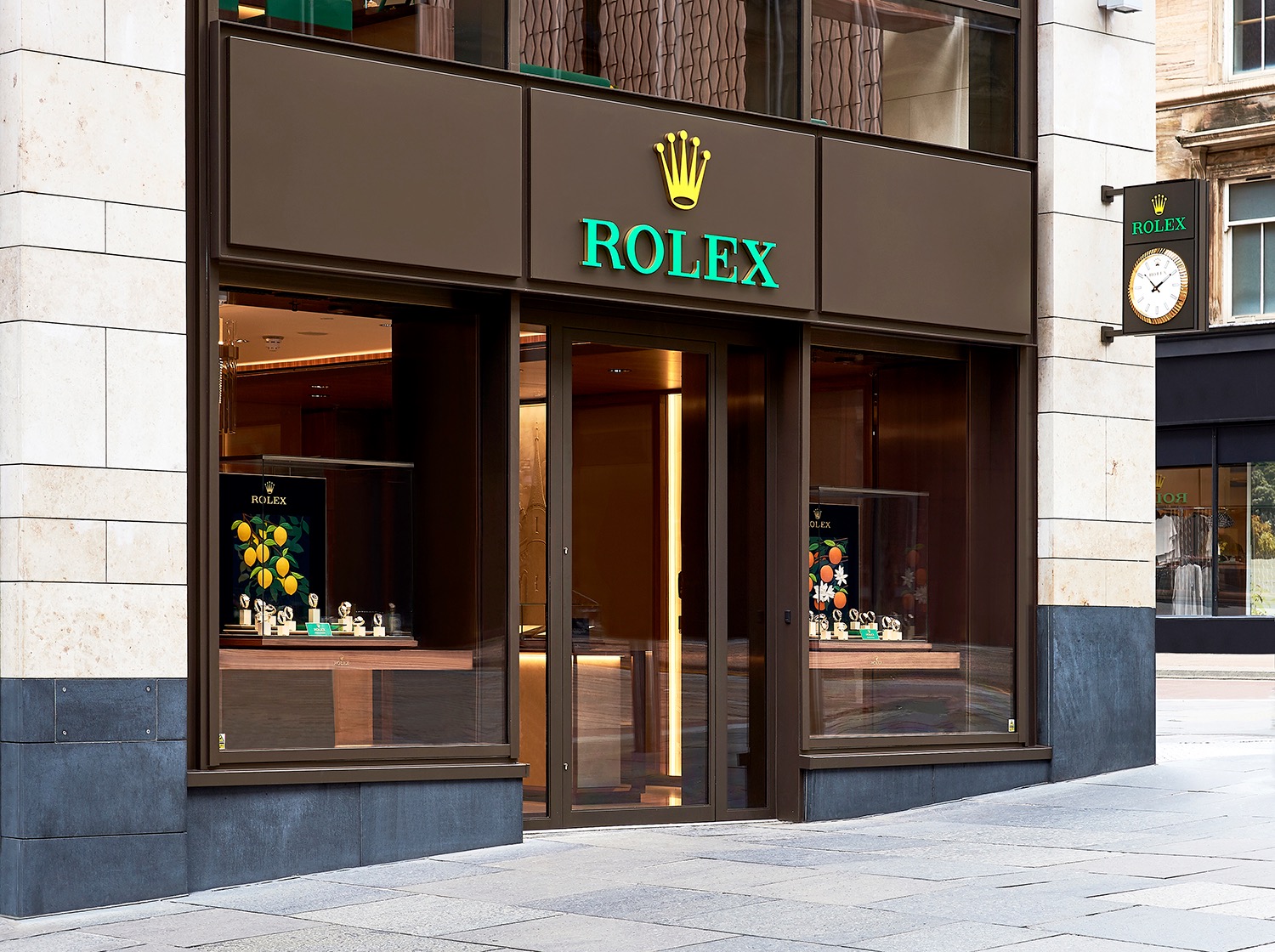 Rolex boutique entrance with bronze-toned frames and dark timber panels